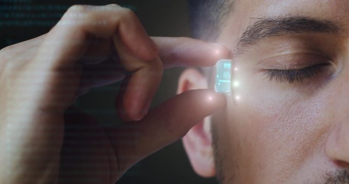 Slow motion of an young male with high innovative futuristic technology augmented reality holographic memory card incorporated in his head.