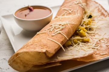 cheese masala dosa recipe with sambar and chutney, selective focus