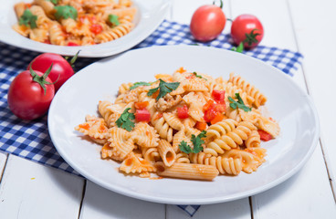Spaghetti pasta with and tomato sauce on wood background