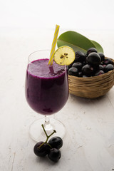 Juice of jamun fruit in a glass also called as java plum, jambolan plum, jambhul, syzygium cumini