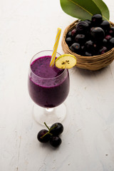 Juice of jamun fruit in a glass also called as java plum, jambolan plum, jambhul, syzygium cumini