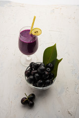 Juice of jamun fruit in a glass also called as java plum, jambolan plum, jambhul, syzygium cumini