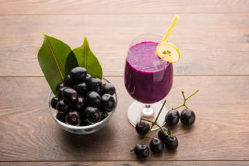 Juice of jamun fruit in a glass also called as java plum, jambolan plum, jambhul, syzygium cumini