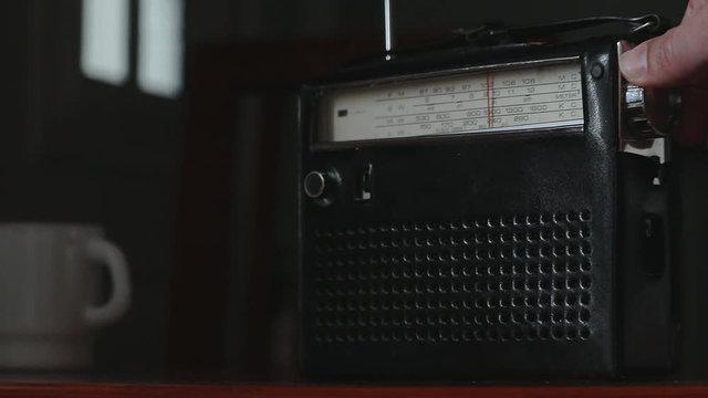 Tuning radio station in a vintage equipment.