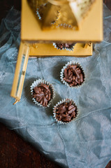 Chocolate Covered Almonds in golden paper cups.
