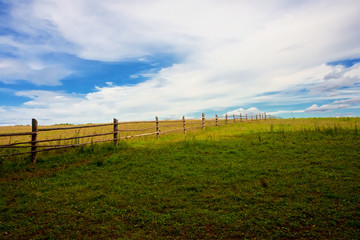 Wooden fence pasture going into the sky