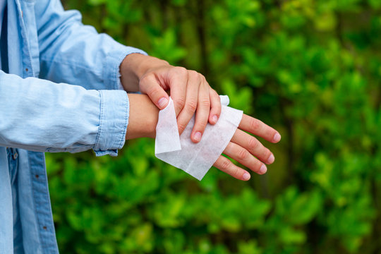 Using Antibacterial Wet Wipes For Disinfection Hands In Park