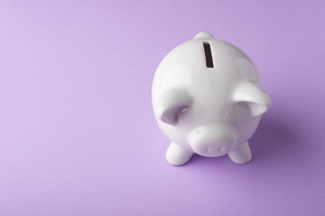Gilt piggy bank on a purple background. Money saving concept. Saving. view from above