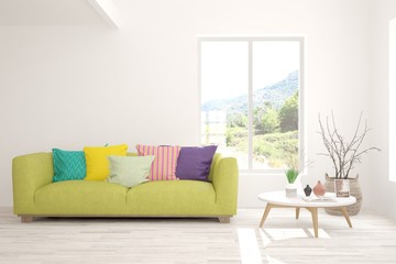 Stylish room in white color with sofa and summer landscape in window. Scandinavian interior design. 3D illustration