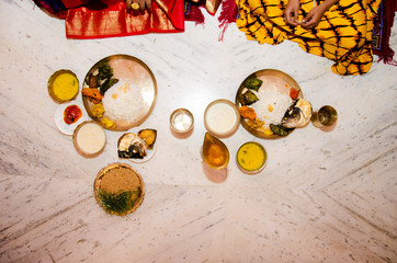 Fototapeta premium Traditional Indian food in brass plate and cup in Indian festival