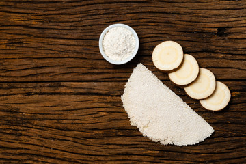 Beiju of tapioca, cassava-based dish typical of the northeastern region of Brazil, now consumed in the whole country on old wooden background.