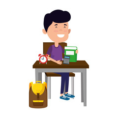 happy student boy with supplies seated in school desk