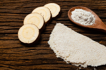 Beiju of tapioca, cassava-based dish typical of the northeastern region of Brazil, now consumed in the whole country on old wooden background.