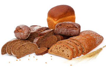 Rye bread, ears of rye and slices on a white background.High fiber content. The concept of a balanced diet. Selective focus, layout, side view.