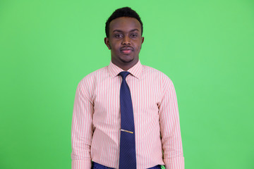 Young African businessman with Afro hair looking at camera
