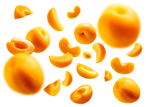 Apricots levitate on a white background. Ripe fruit in flight