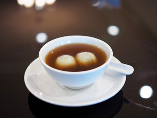 Black Sesame Dumplings in hot Ginger syrup, This menu is a Chinese dessert which popular in Thailand. Sticky rice balls stuffed with grounded black sesame add sweetened ginger for more good taste.