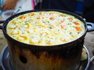 Thai Pan Fried Seafood Omelette or takoyaki in Thai style with crab stick, oyster and squid. Selective focus.