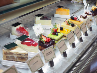 Variety of cake such as strawberry fresh cream, chocolate fudge, mango, tiramisu and pistachio cake in freezer dispaly cake.