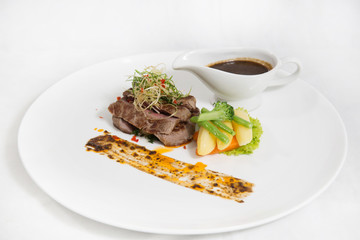 Beef fillet mignon steak gourmet with carrot and fried potatoes