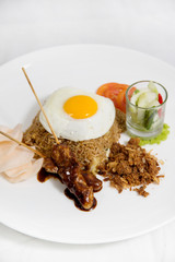 Fried rice with chicken satay, egg and crackers