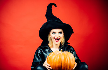 Happy Halloween. Young women in black witch halloween costumes on party over red background. Halloween concept.
