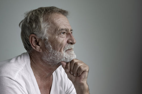 senior man thinking or try to remember alone closeup