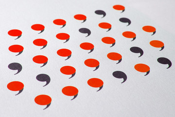 black comma in many red commas.