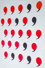 black comma in many red commas.