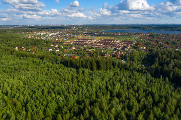 Fototapeta na wymiar Aerial view on the countryside, the village and the lake on the horizon on a summer day