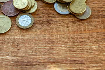 coins Pile pack heap on a wooden background with space for an inscription copy space mock up selective focus close up