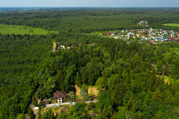 Aerial view on the countryside and the village  on the horizon on a summer day