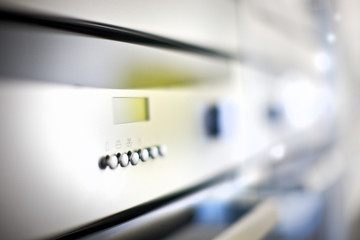 Modern stove control panel buttons on the bottom close up