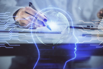 Multi exposure of woman's writing hand on background with brain hologram. Concept of brainstorming.