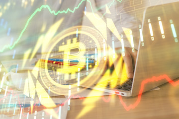 Crypto currency theme hologram with businessman working on computer on background. Concept of...