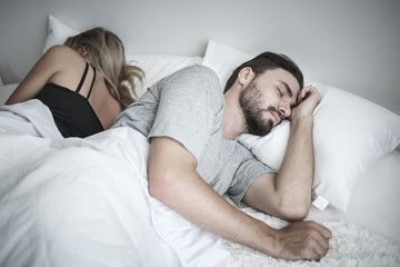 Unhappy or upset couple sleeping in bed, ignoring each other avoiding sex, having conflict or sexual problems concept