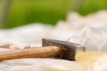 Wooden rusty hammer isolated amongst other tools