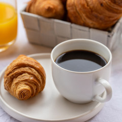 French breakfast, hot cup of coffee with croissants and orange juice. Good morning concept background.