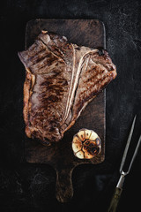 Grilled Dry Aged Beef T-bone Steak on Vintage Cutting Board