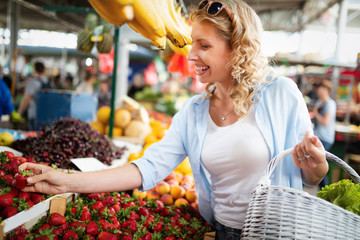 Young woman shopping healthy food on the market