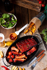 Grilled ribs in spicy marinade with salad and vegetables