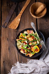 Pasta salad with green asparagus, olives and parma ham