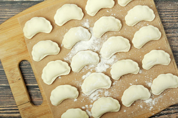 The process of cooking traditional vareniki - textured background	