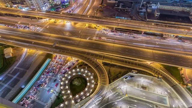 Aerial view of highway interchange in Dubai downtown night timelapse. Al Saada street and Financial center road. Cityscapes traffic bridge, logistics. Roads and lanes Crossroads, Dubai, United Arab