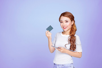 Asian young beautiful attractive pretty female student holding credit card and smart phone