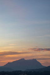 Sunset view of a mountain range with orange and blue sky
