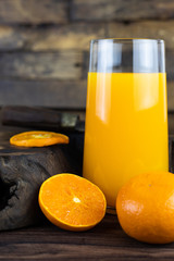 Fresh healthy orange juice, smoothie in a glass on wooden background. summer concept.