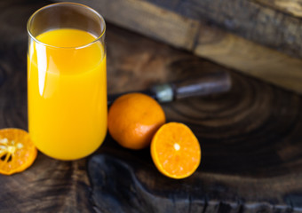 Fresh healthy orange juice, smoothie in a glass on wooden background. summer concept.