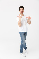 Full length portrait of a cheerful young man