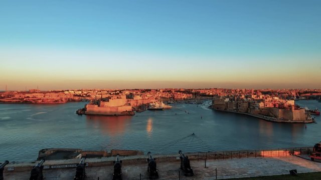 Day to night sunset time lapse of Vittoriosa and Senglea bay seen from Valletta (Malta)